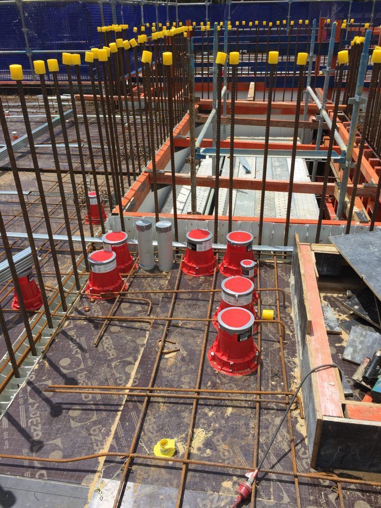 A construction site with a bunch of red cones on the ground