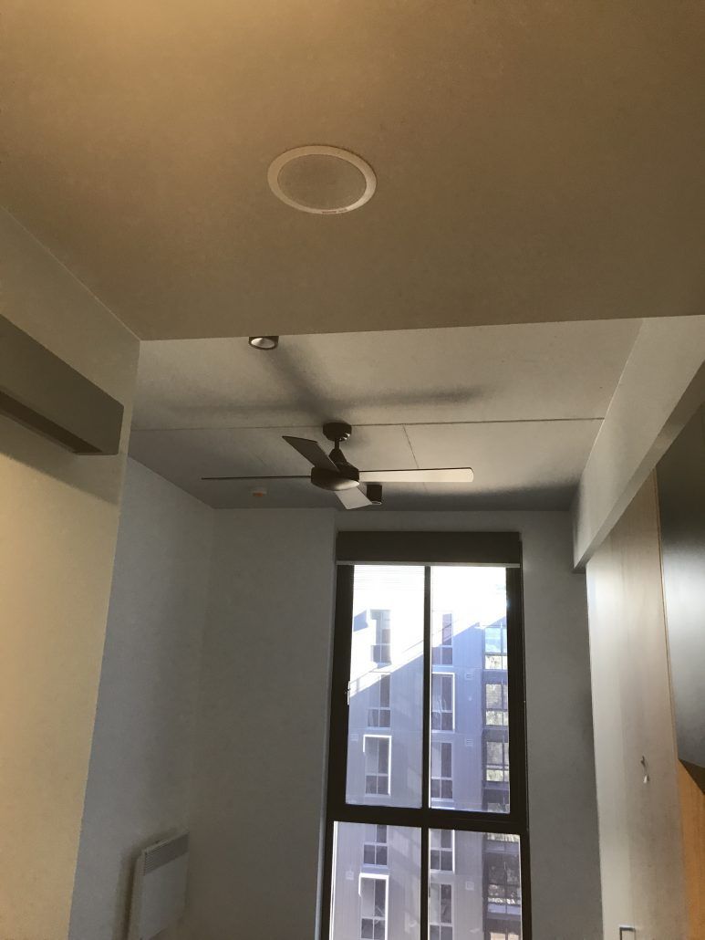 A room with a ceiling fan and a window
