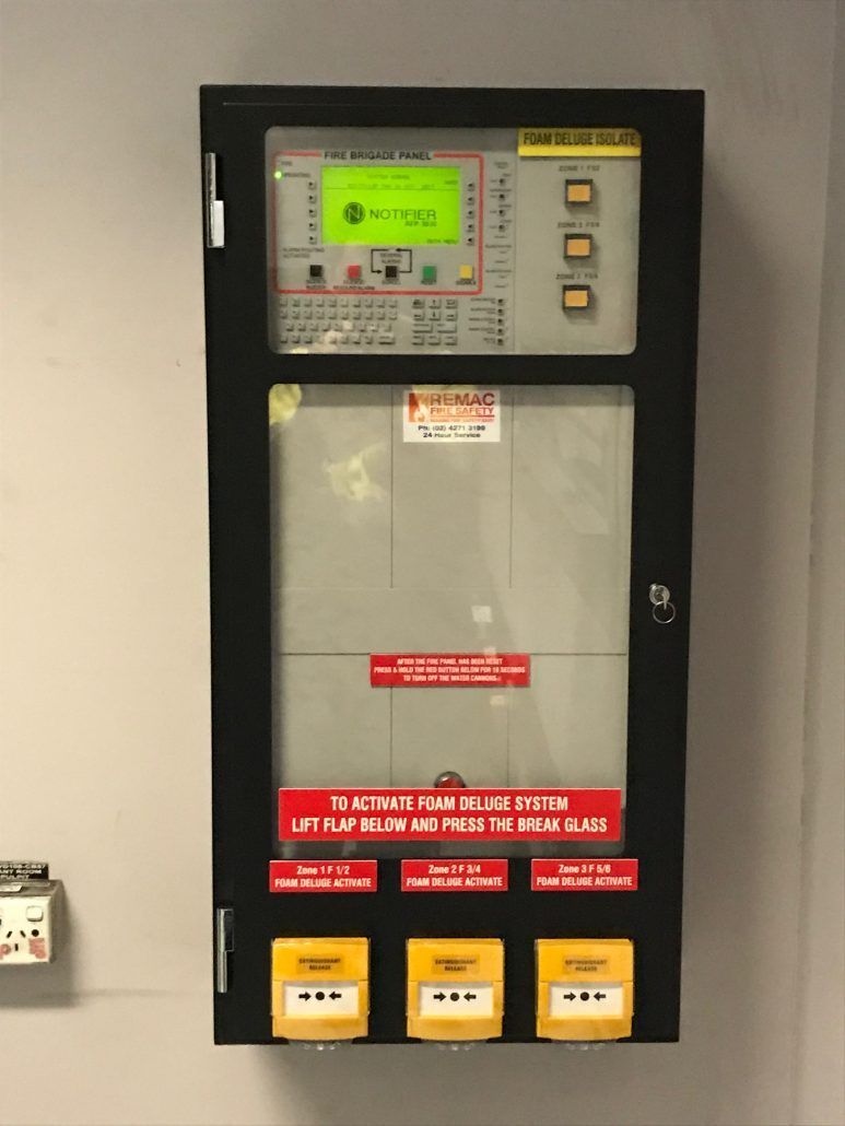 A fire alarm system is hanging on a wall