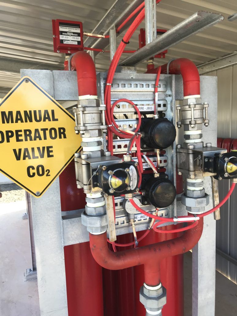 A yellow sign that says manual operator valve co2