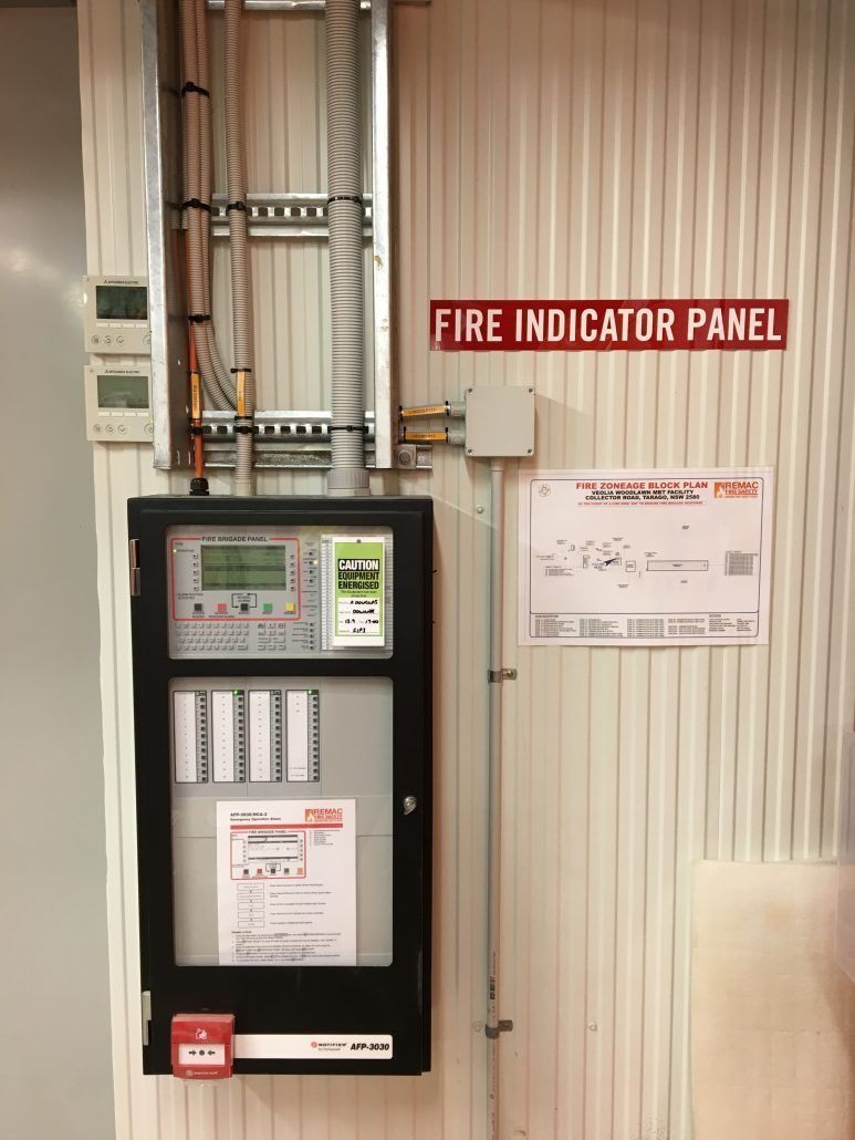 A fire indicator panel is hanging on a wall