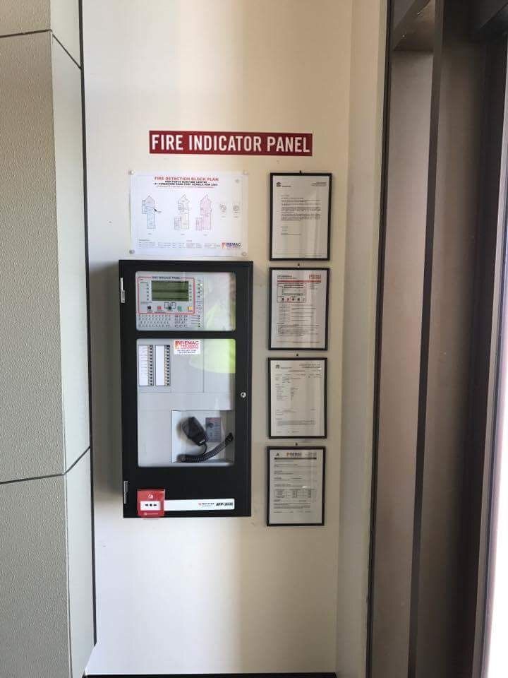 A fire indicator panel is hanging on a wall
