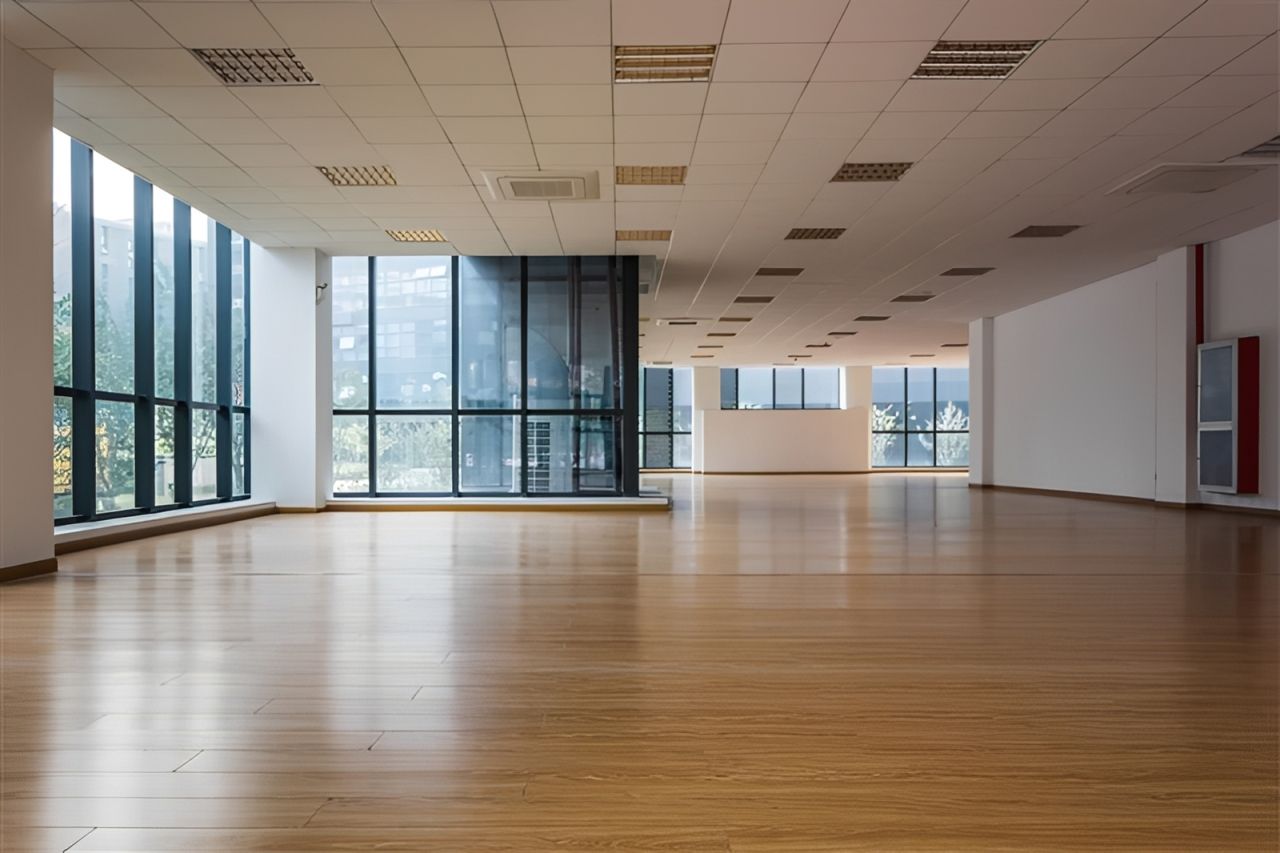 The empty interior of a modern corporate office with high ceilings.