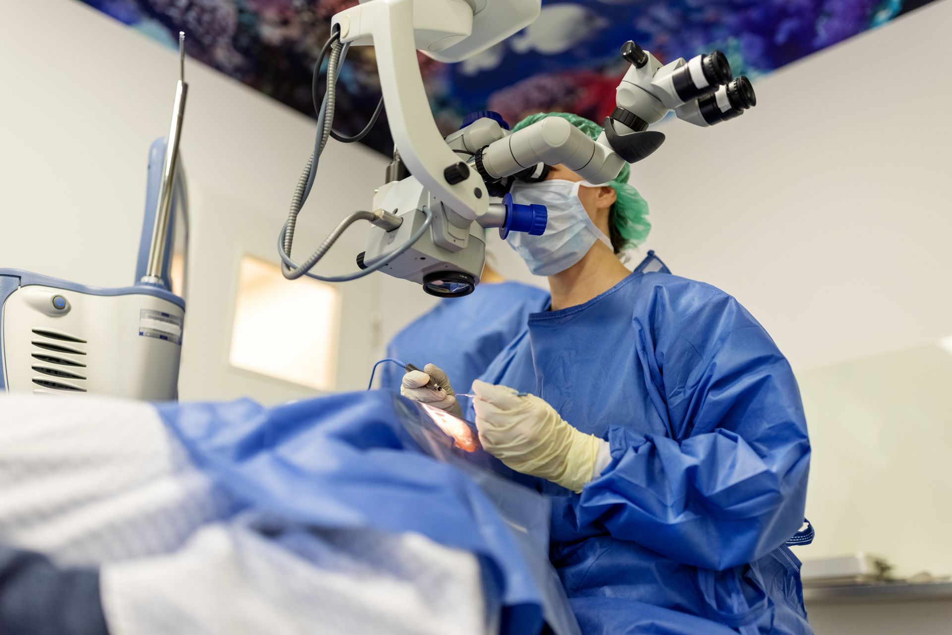 A professional ophthalmologist performing cataract surgery using a microscope in a modern clinic.