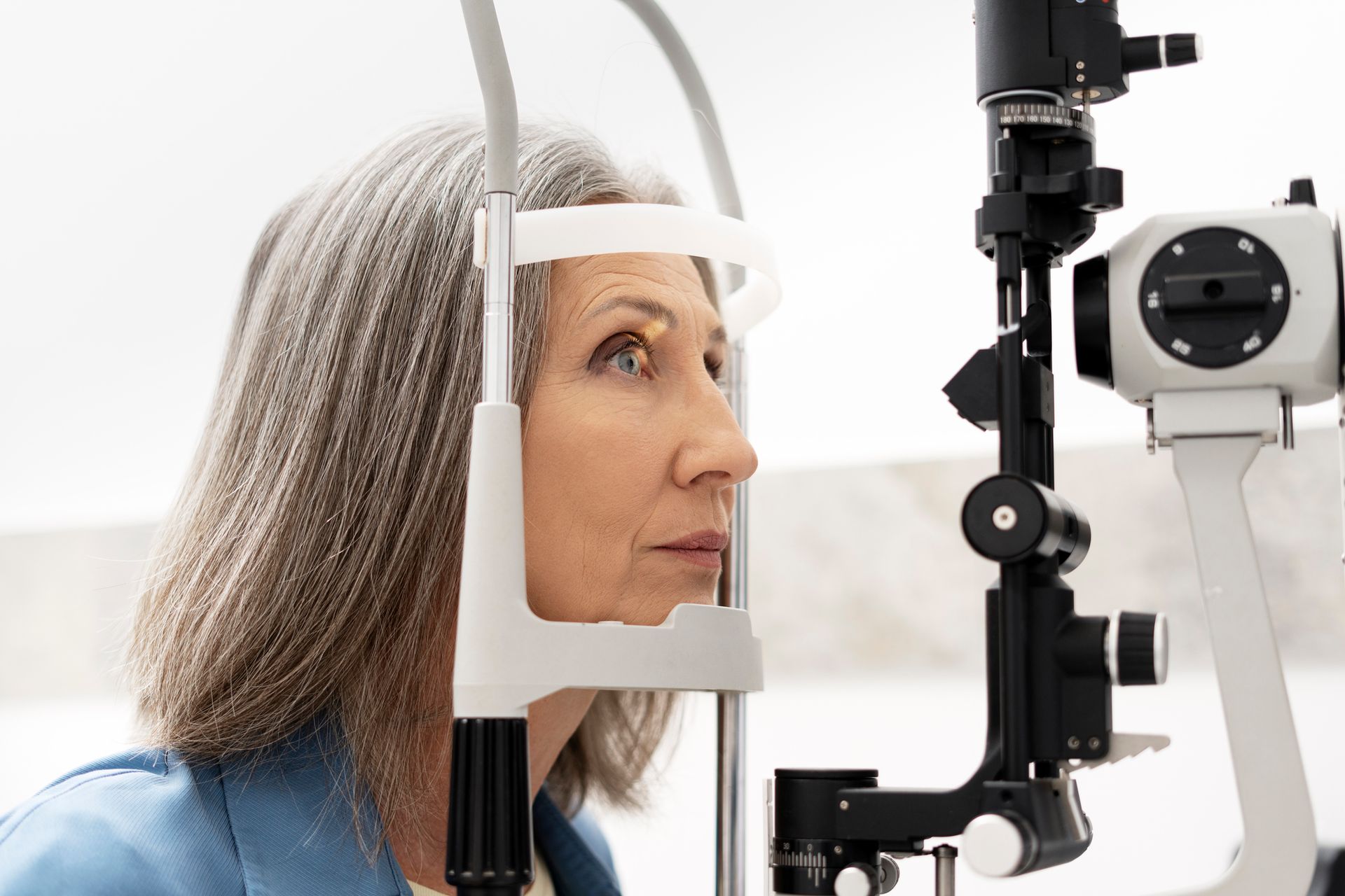 Senior woman undergoing eye exam with slit lamp - Caulfield Cataract Surgery