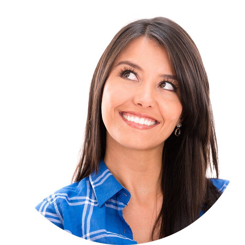 A woman in a blue shirt is smiling and looking up | eye clinic in Melbourne