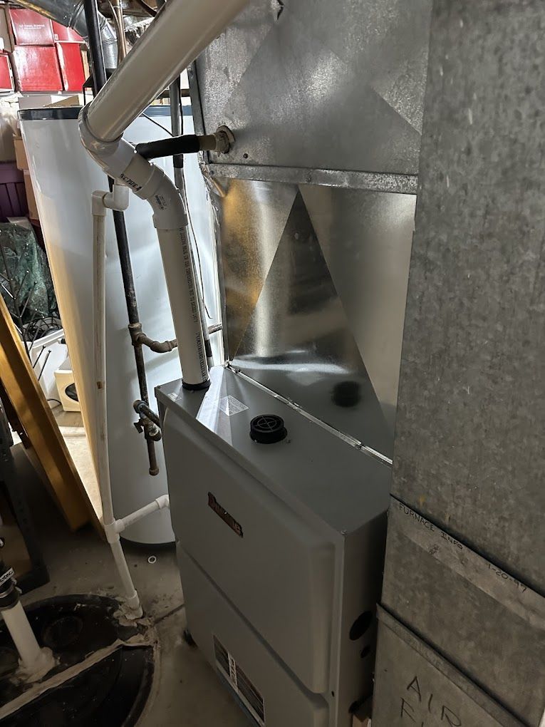 A heater is sitting in a room next to a wall.