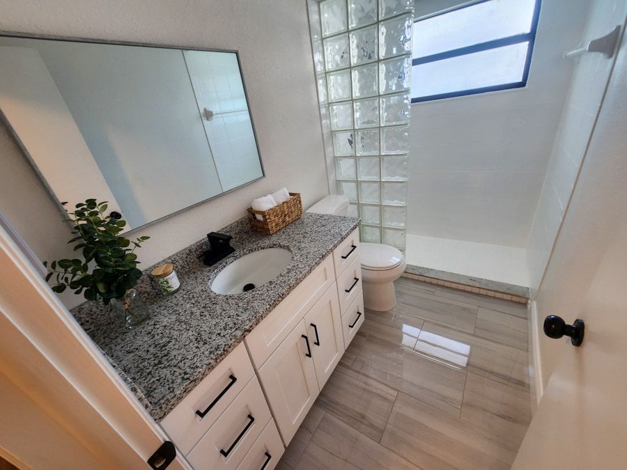 A bathroom with a sink , toilet and mirror