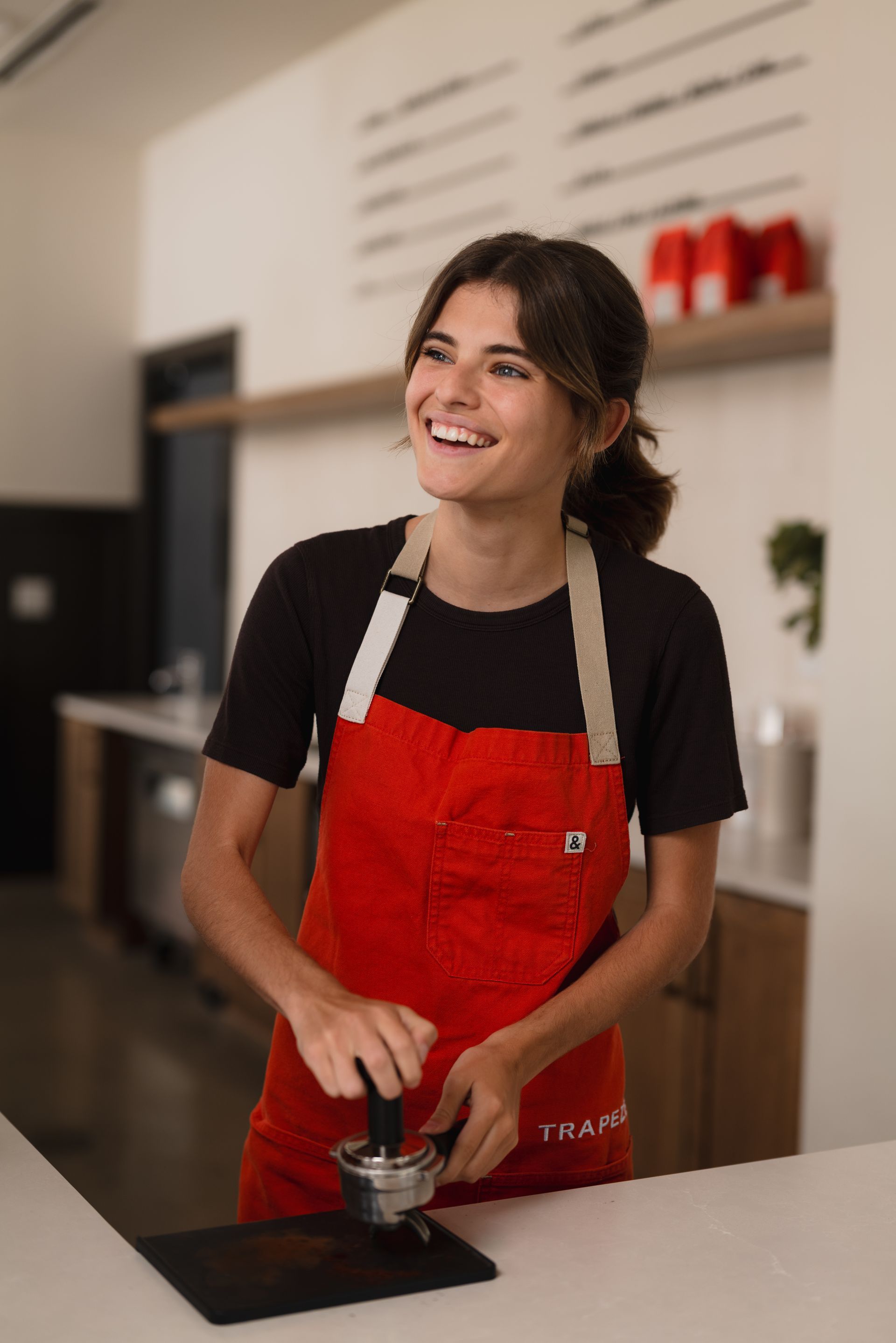 Girl in red apron.