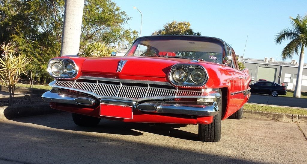 A red car is parked on the side of the road — Pialba Brake Clutch & Steering in Pialba, QLD