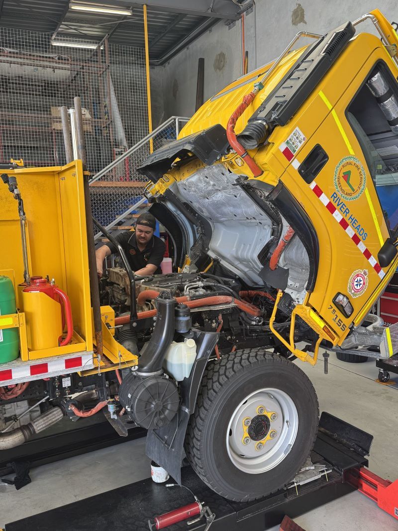 A Man Is Working on The Engine of A Truck — Pialba Brake Clutch & Steering in Pialba, QLD