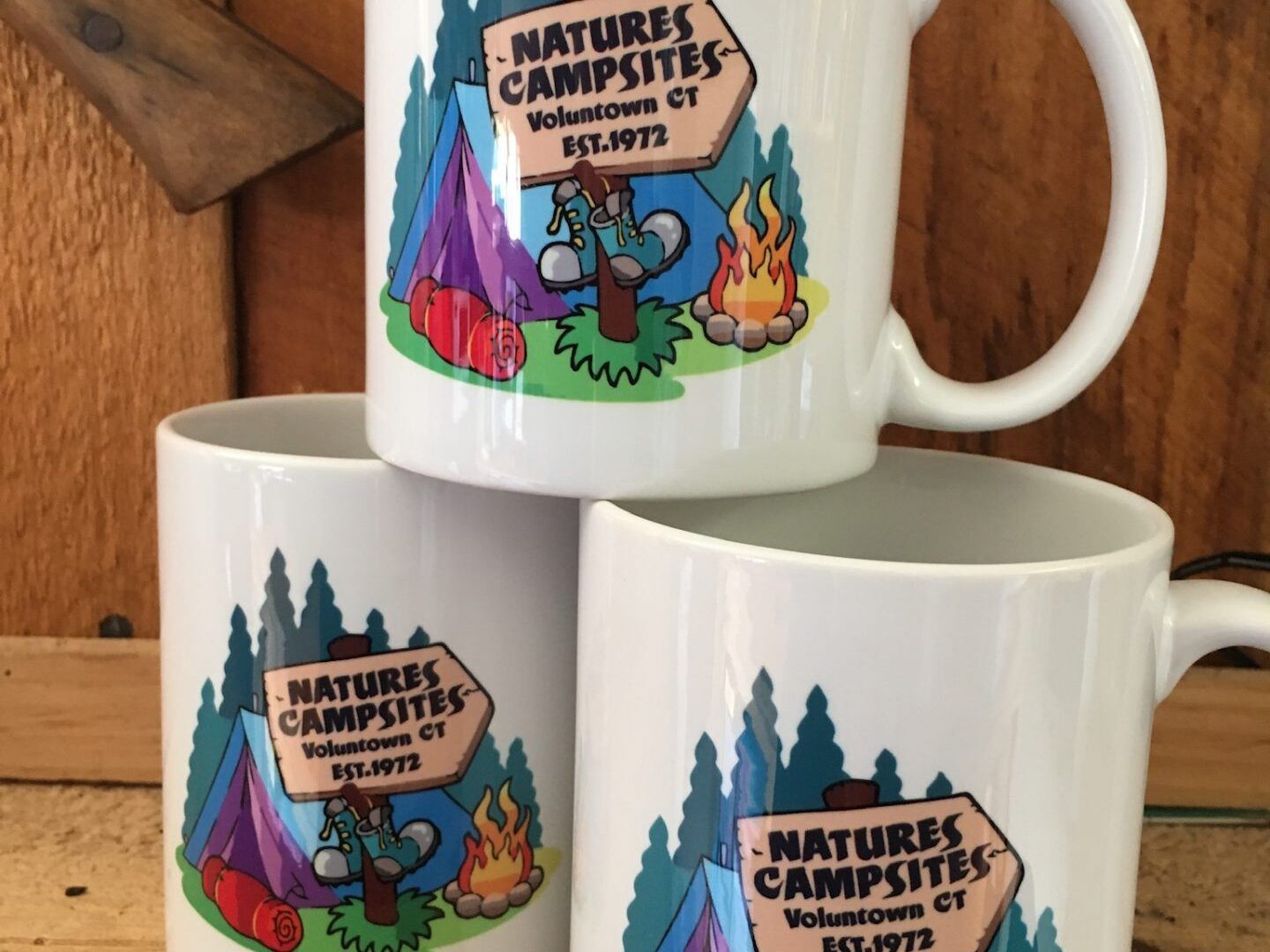 Three natures campsites mugs are stacked on top of each other