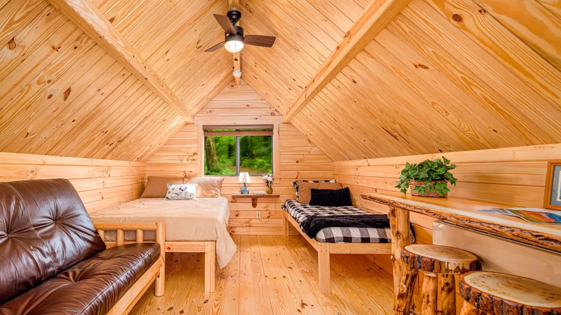 A rv is parked in a campground in the woods.