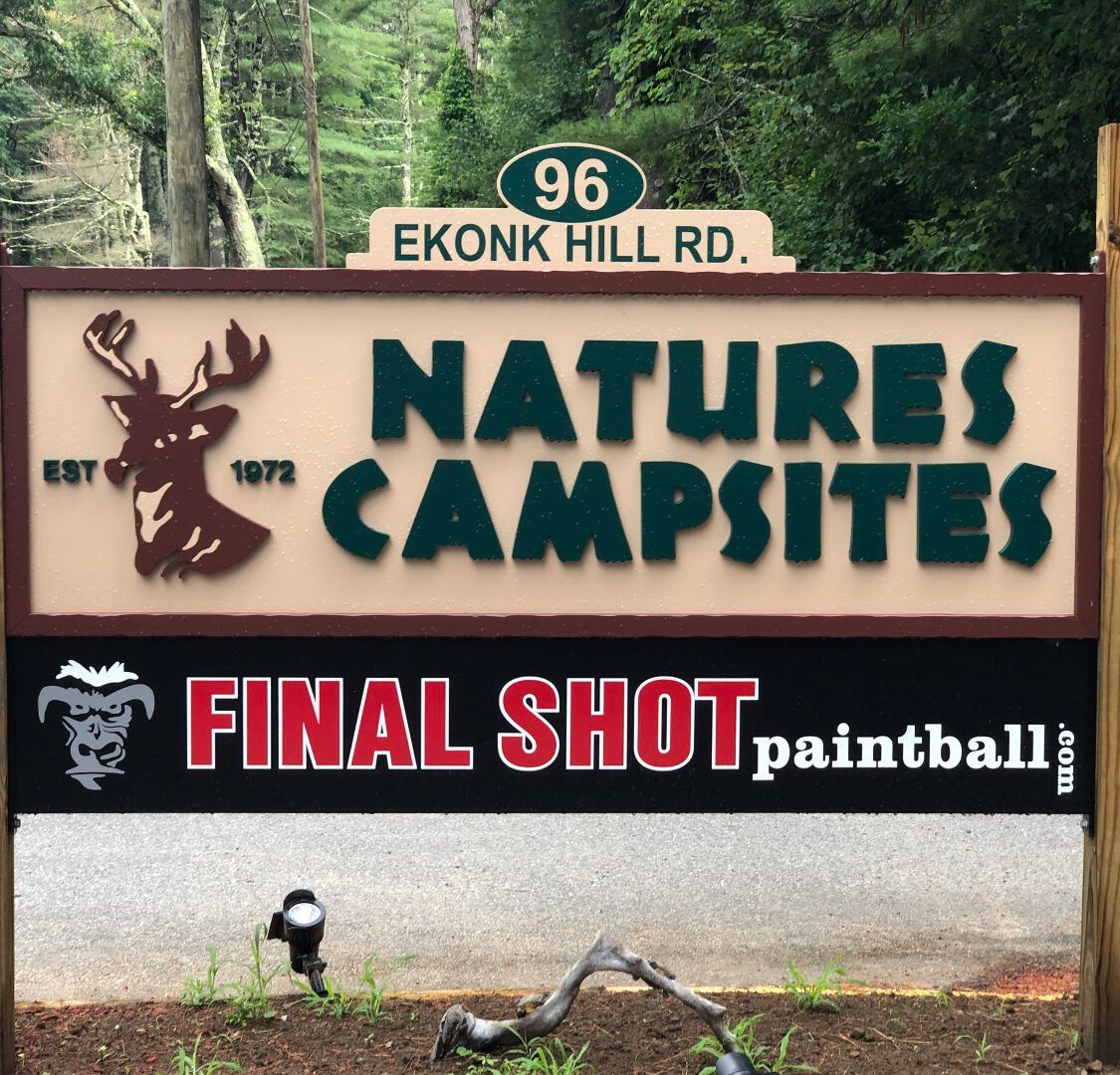 A sign for natures campsites has a deer on it