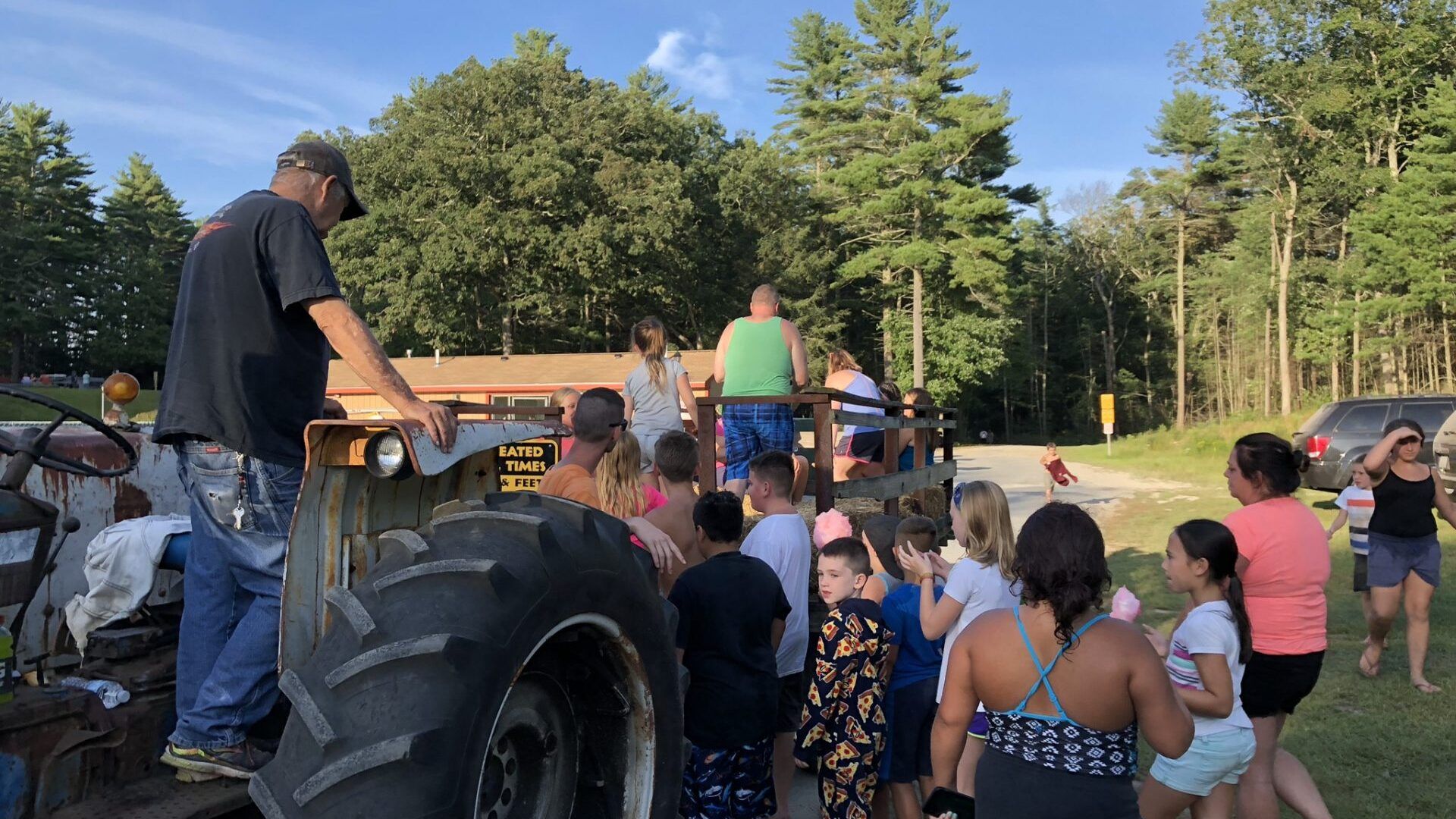 A group of people are standing around a tractor.