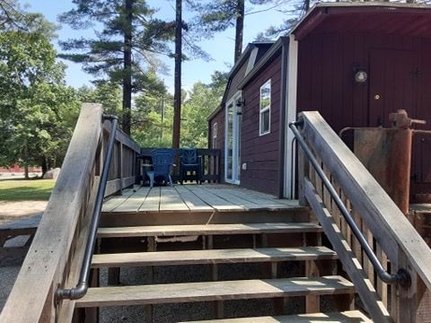 A wooden deck with stairs leading up to it