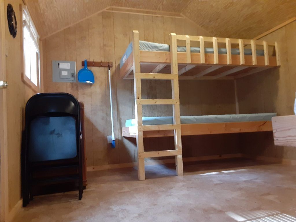 A room with bunk beds and a television