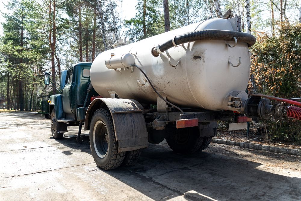 Blue Septic Tank Truck on a Paved Road — MG Earthworks and Plant Hire in Gumma, NSW