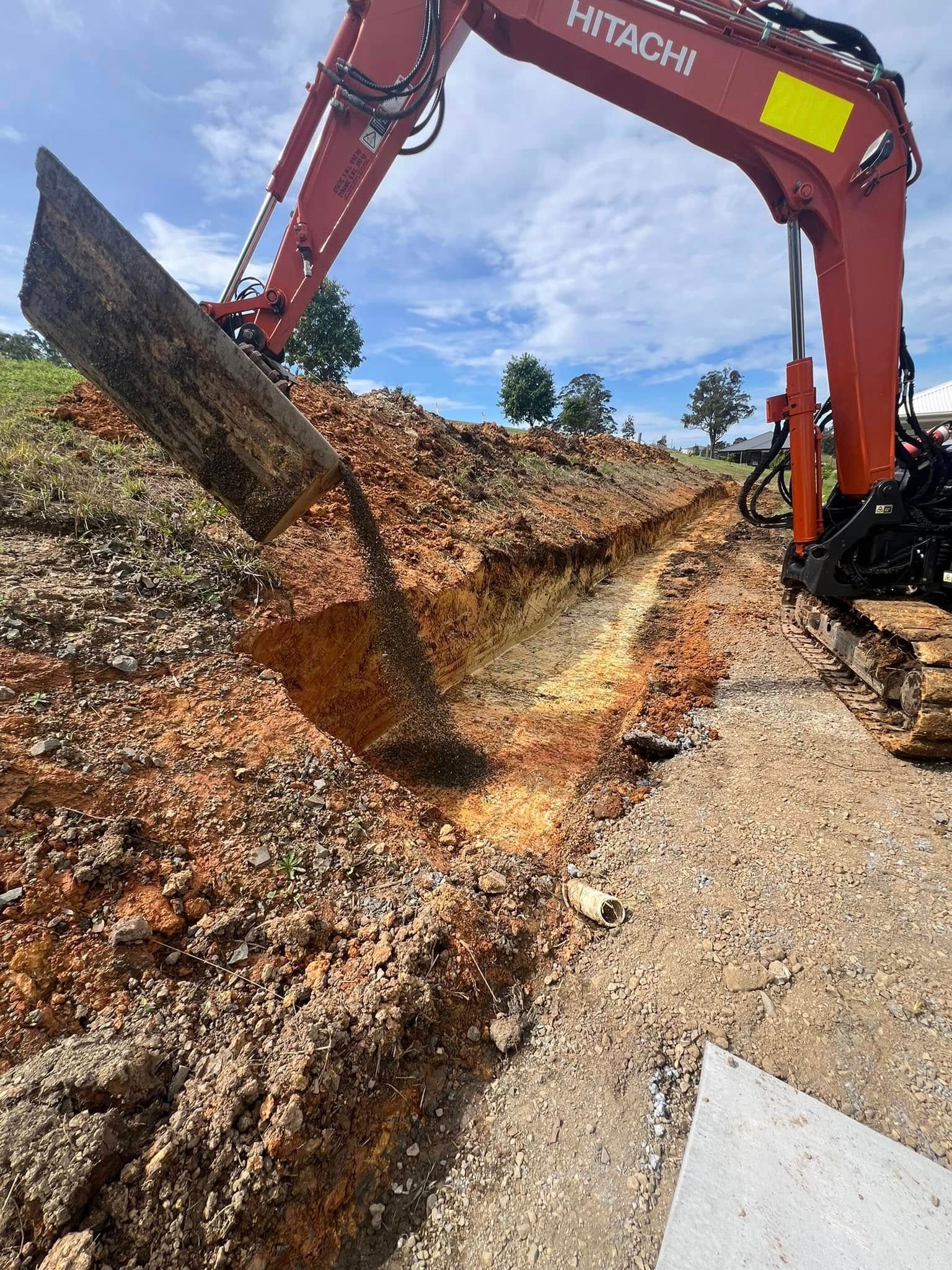 An Orange Hitachi Excavator Digging a Trench — MG Earthworks and Plant Hire in Bellingen, NSW