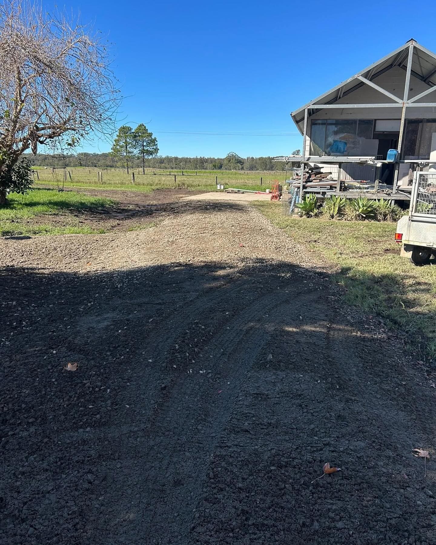A Gravel Driveway Leads to a Rural Home With a Porch — MG Earthworks and Plant Hire in Coffs Harbour, NSW
