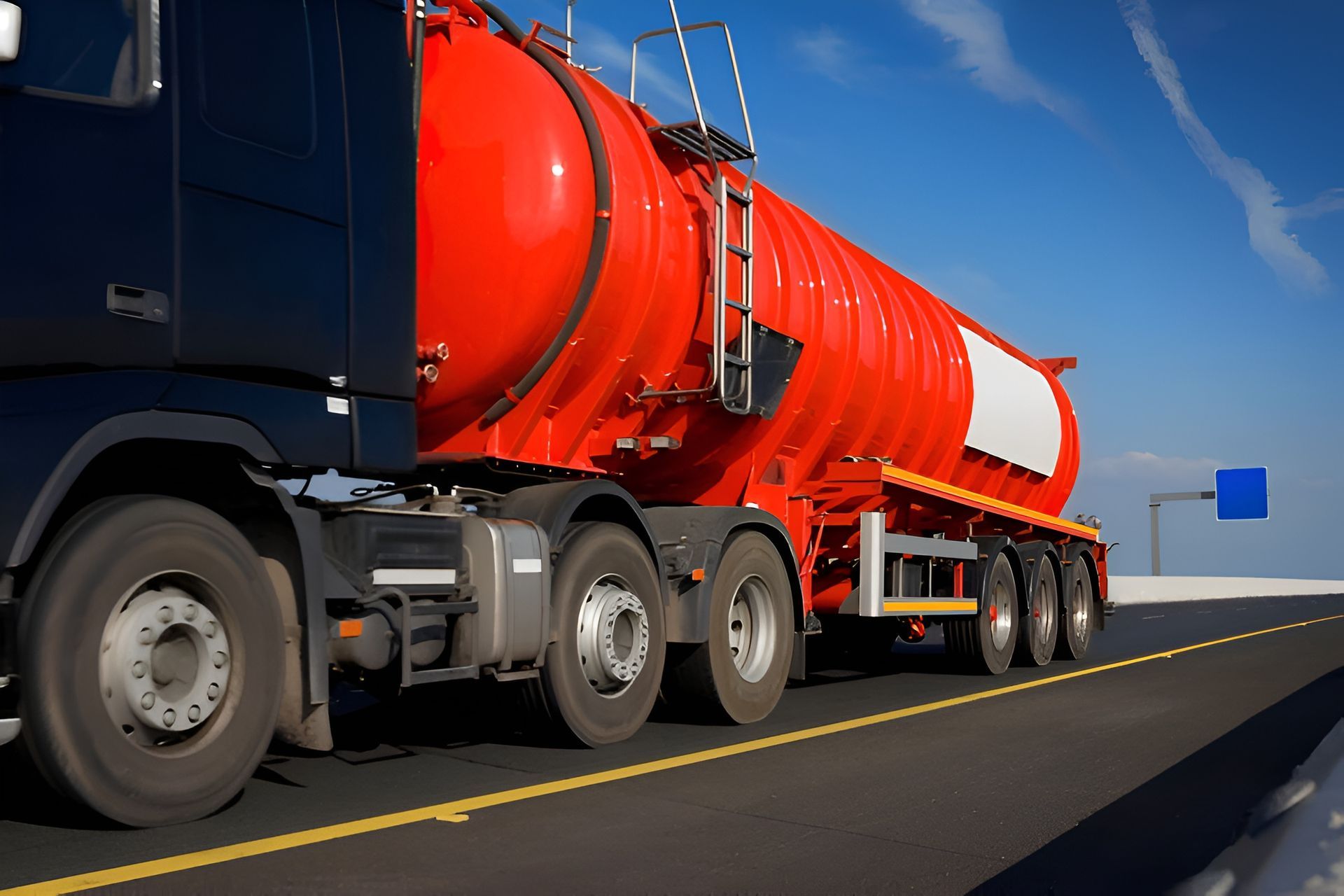 Black and Red Tanker Truck Driving on Highway Under Blue Sky — MG Earthworks and Plant Hire in Gumma, NSW