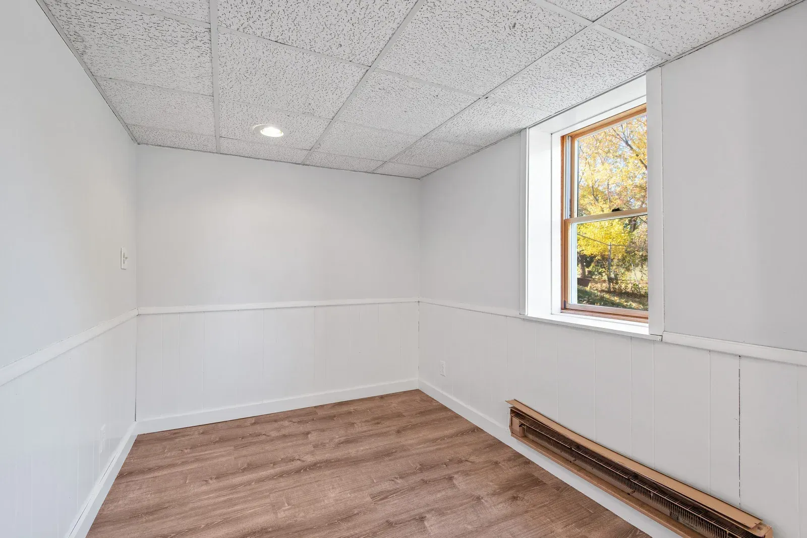 There is a window in the corner of the room.