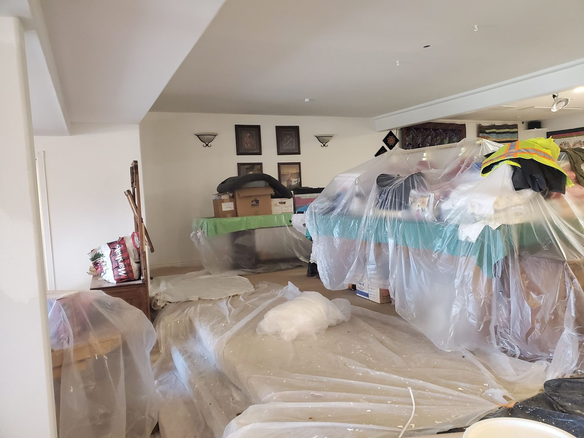 A living room with a lot of plastic bags on the floor