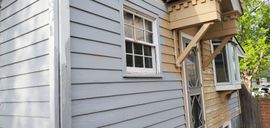A small house with a porch on the side of it