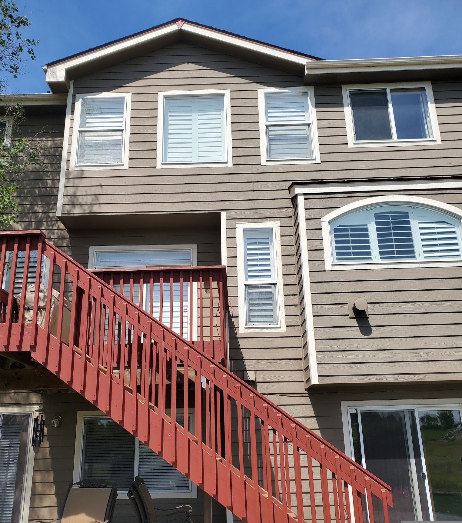 A house with a red staircase leading up to it