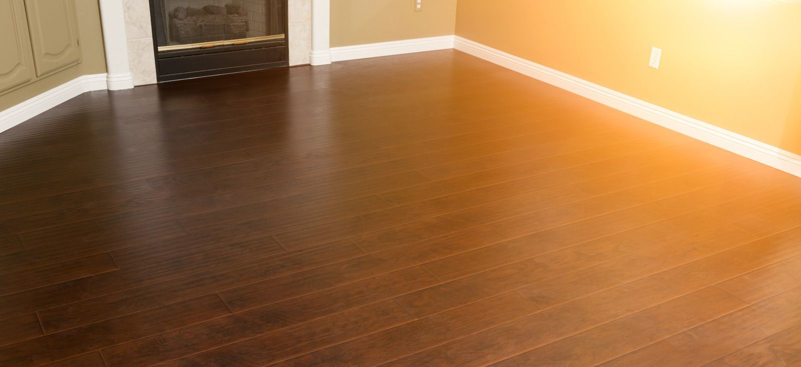 A living room with hardwood floors and a fireplace.