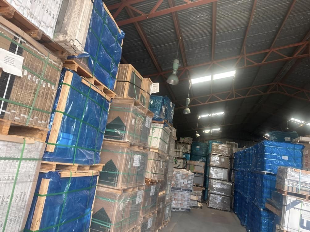 A Large Warehouse Filled With Lots Of Boxes And Pallets — Tile Centre NT In Winnellie, NT