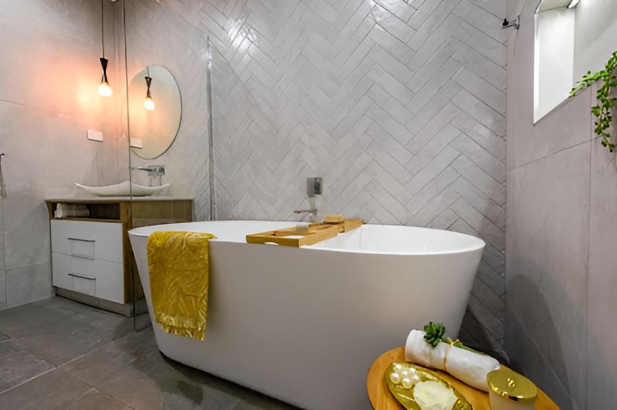 A Bathroom With A Bathtub, Sink And Mirror — Tile Centre NT In Winnellie, NT