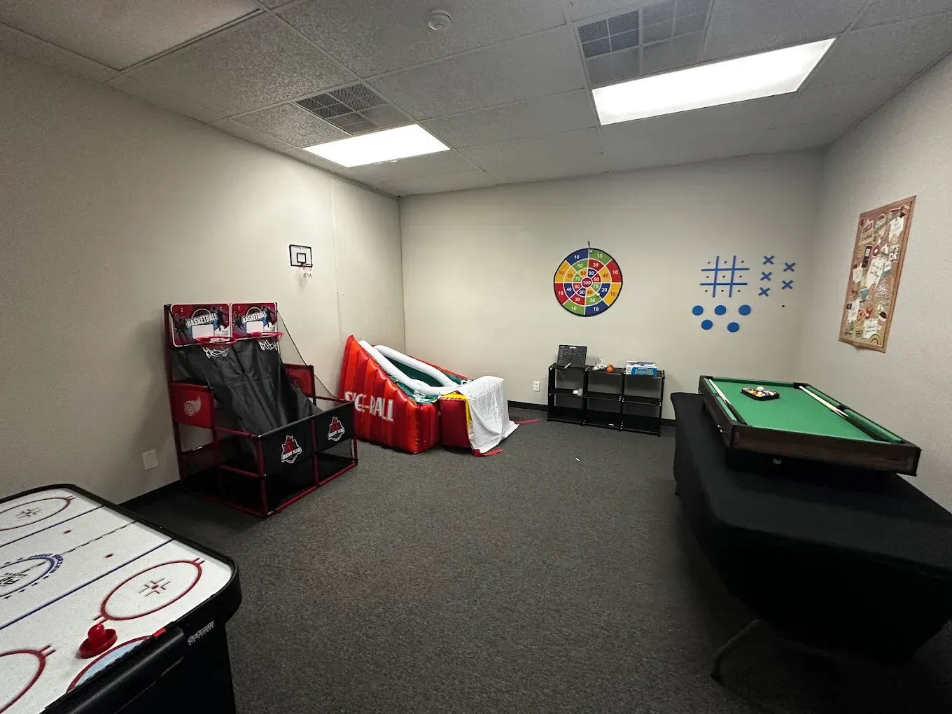 There is a pool table in the middle of the room.