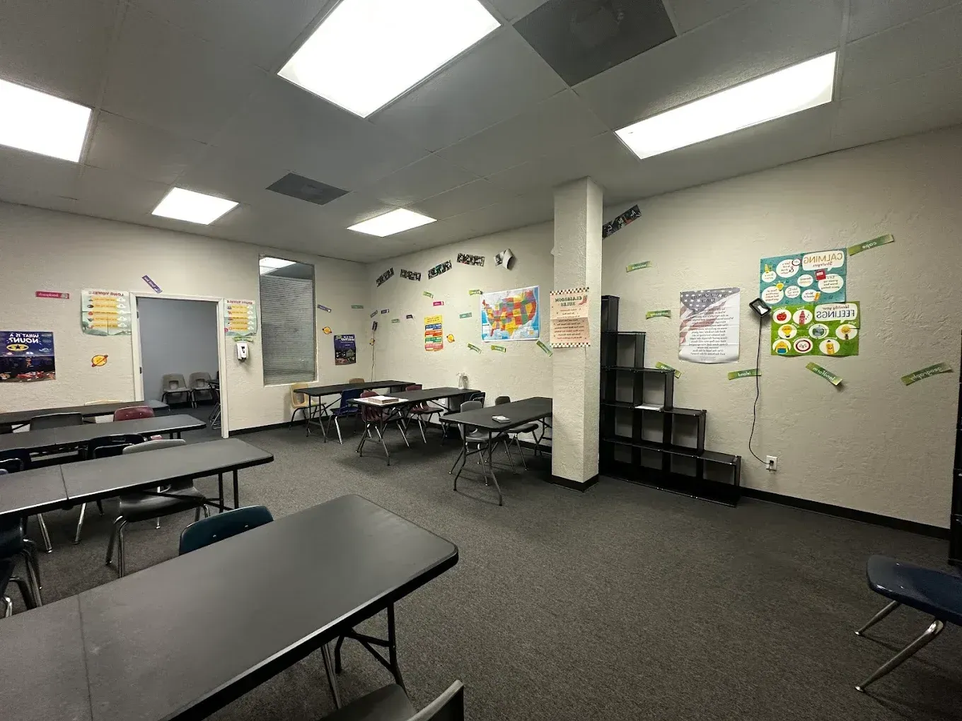 A large room with tables and chairs in it.