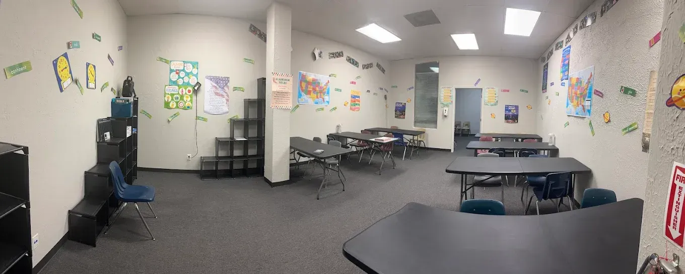 A large room with tables and chairs in it.