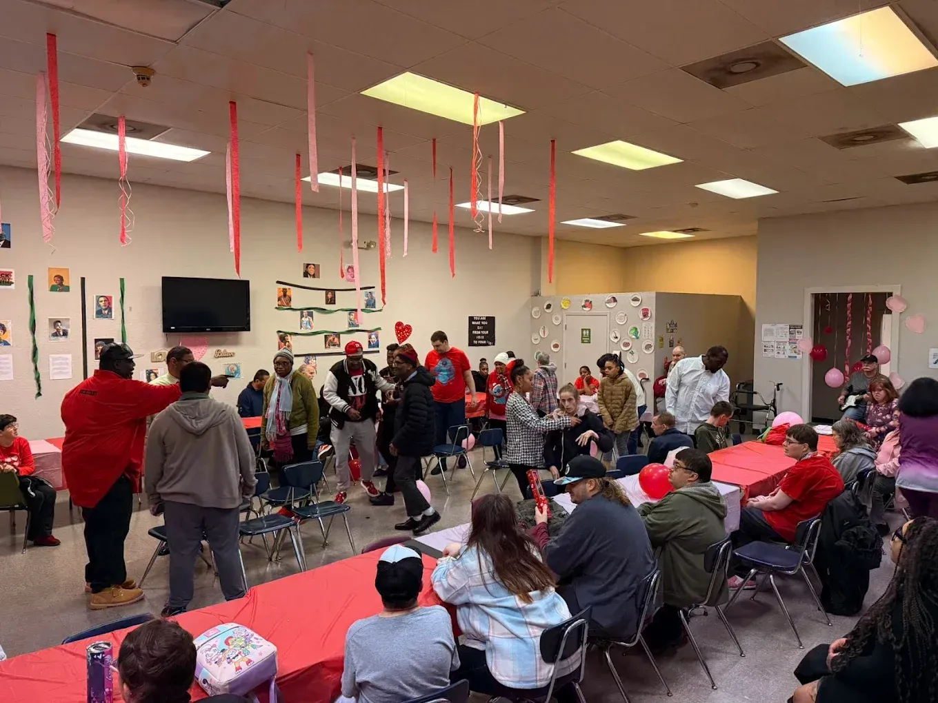 A group of people are sitting at tables in a room.