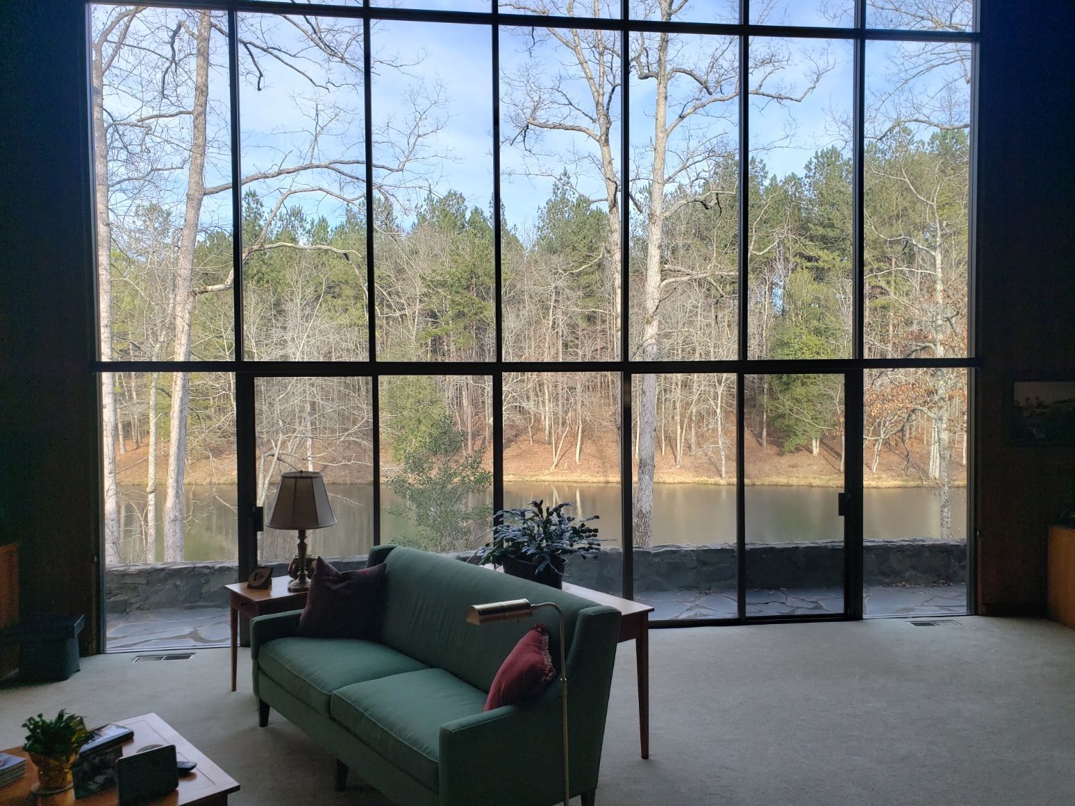A living room with a couch and a view of a lake