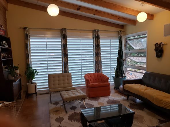 A living room with a couch and two chairs