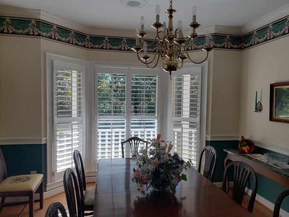 A dining room with a table and chairs and a chandelier