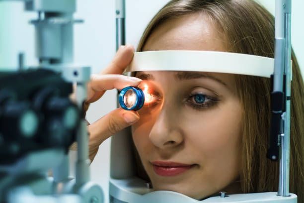A Person Having an Eye Exam With a Slit Lamp — Peninsula Eyecare Izzards Optometrists in Empire Bay, NSW