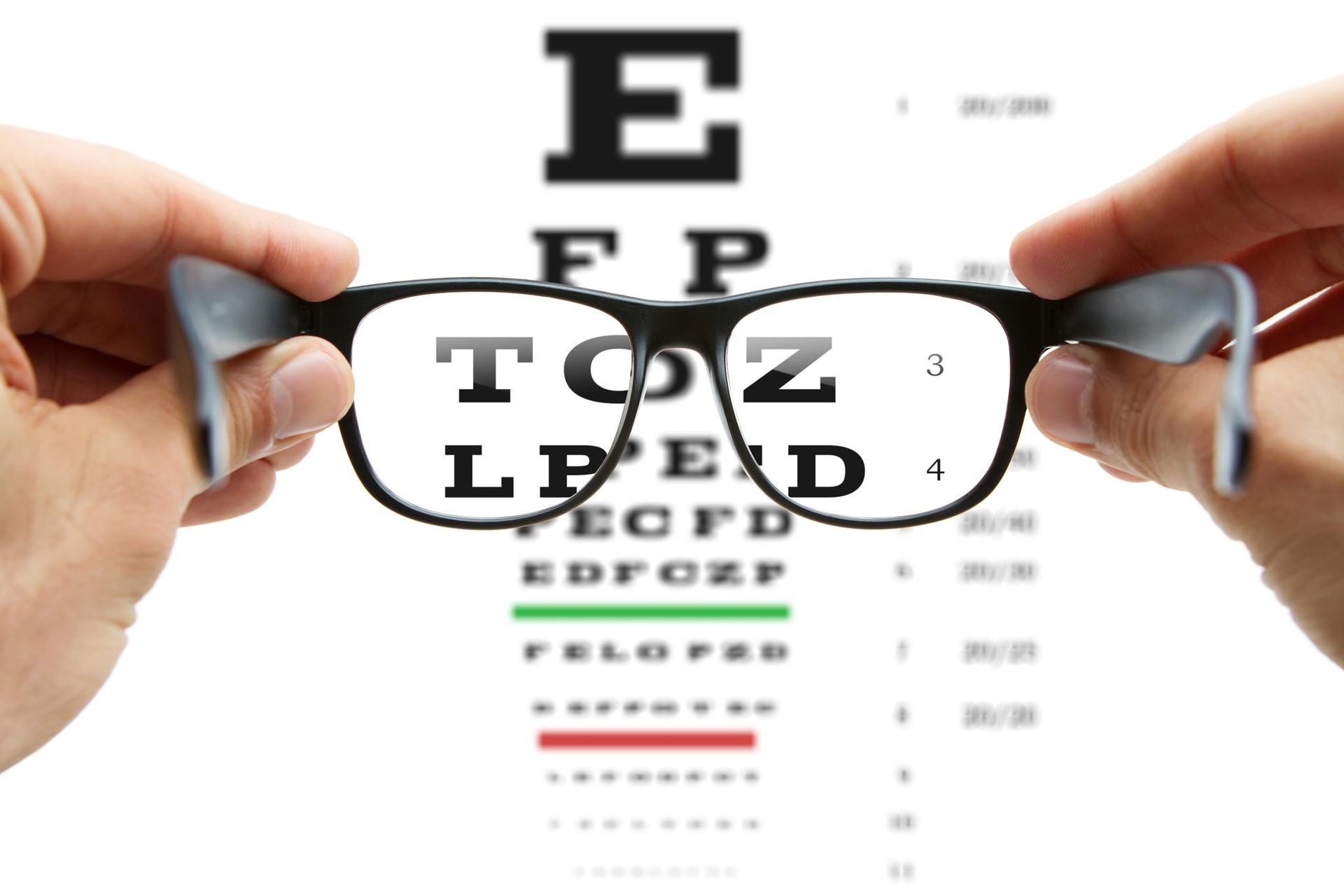 Hands Holding Black-rimmed Glasses — Peninsula Eyecare Izzards Optometrists in Woy Woy, NSW