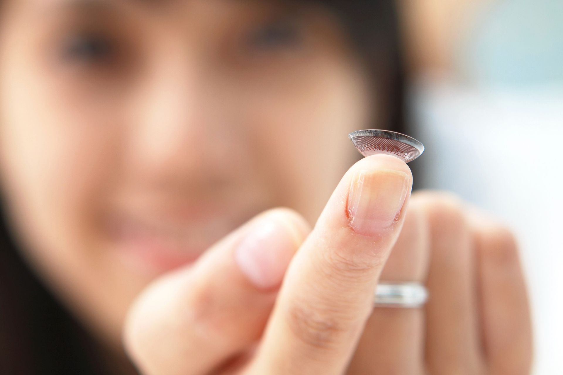 A Contact Lens Sits on the Tip of a Person's Index Finger — Peninsula Eyecare Izzards Optometrists in Point Clare, NSW