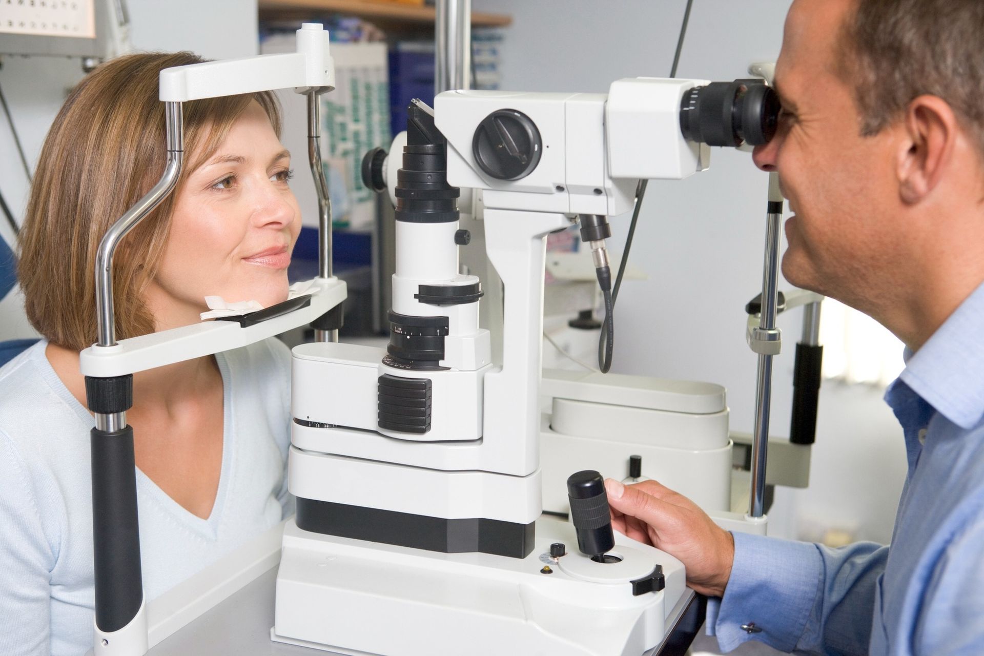 A Professional Eye Doctor Using a Slit Lamp Microscope — Peninsula Eyecare Izzards Optometrists in Woy Woy, NSW