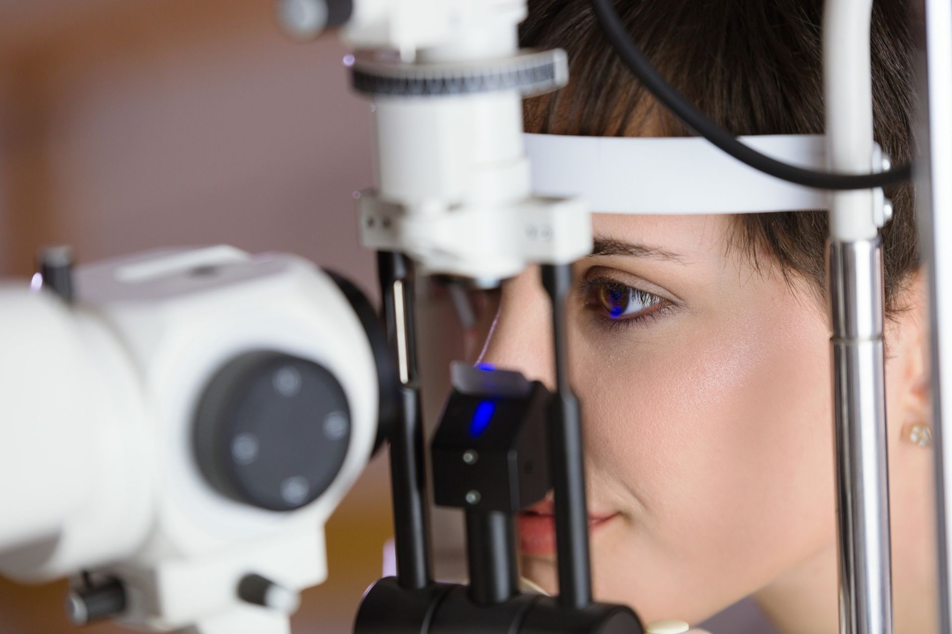 A Person Sits With Their Chin in a Slit Lamp — Peninsula Eyecare Izzards Optometrists in Woy Woy, NSW