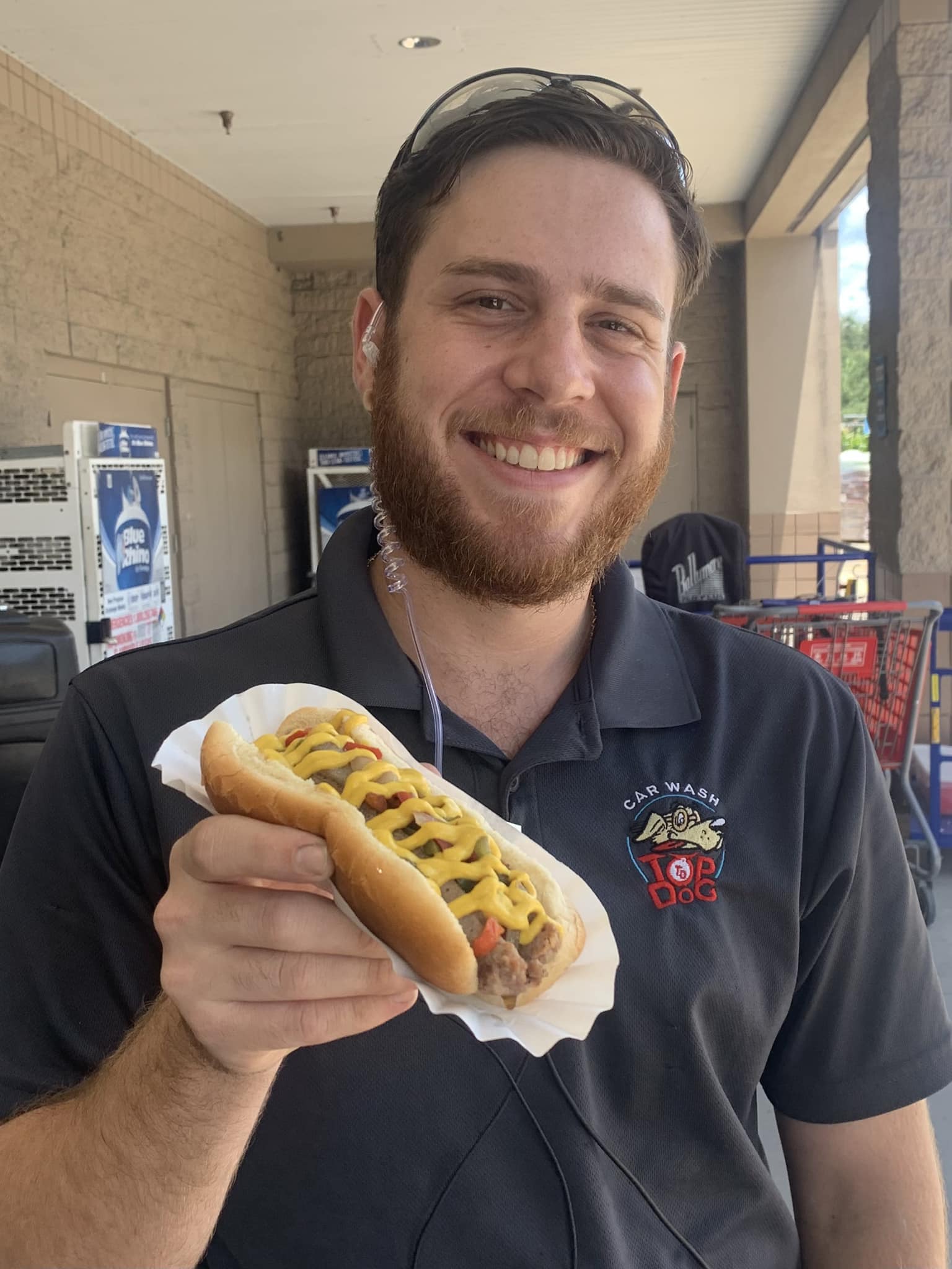 A Man Holding A Hotdog In A Bun — Orlando, FL — The Hot Dog Guy Catering