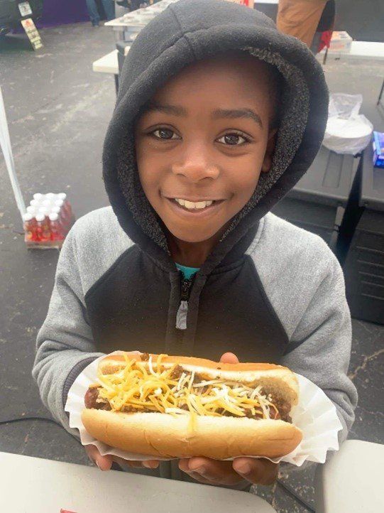 A Young Boy Happy With His Cheesy Hot Dog — Orlando, FL — The Hot Dog Guy Catering