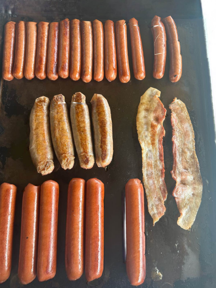 Hotdogs And Bacon Being Cooked — Orlando, FL — The Hot Dog Guy Catering