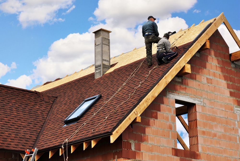 Two Roofers Working on a Red-shingled Roof — Wilko Plate (Aust) Pty Ltd in Innisfail, QLD