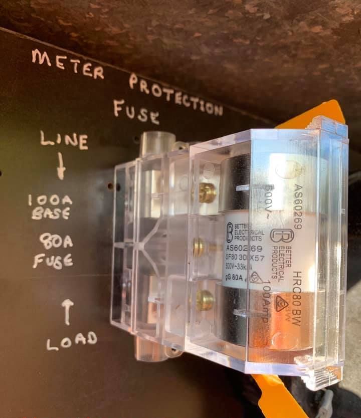 An Electrician is Working on an Electrical Box With a Multimeter — Gunter Electrical In Woy Woy, NSW