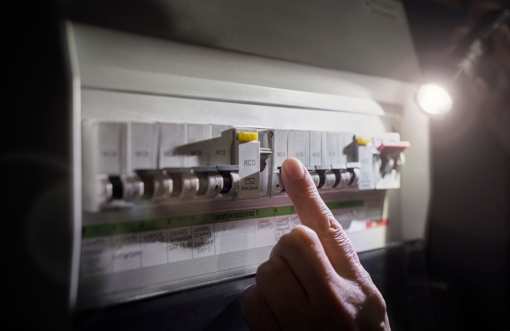 A Person is Fixing an Electrical Box Without Power — Gunter Electrical In Kariong, NSW